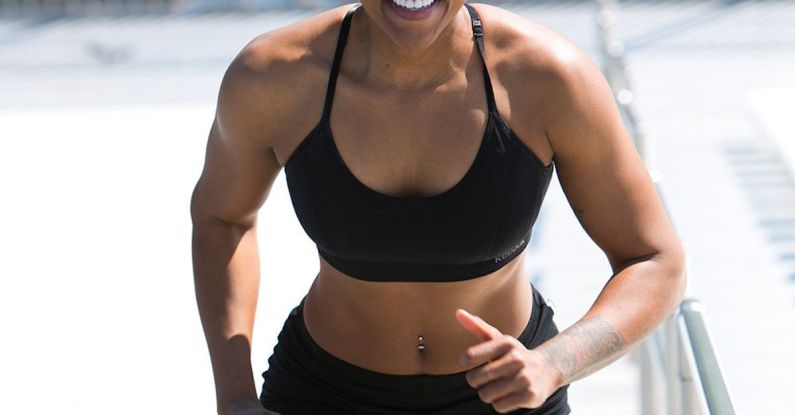 Weight Constraints - Woman Wearing Black Sports Bra and Jogger Shorts Smiling