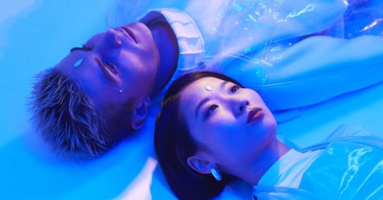Automation - Futuristic Photo of a Young Man and Woman Lying on the Floor in Blue Lighting