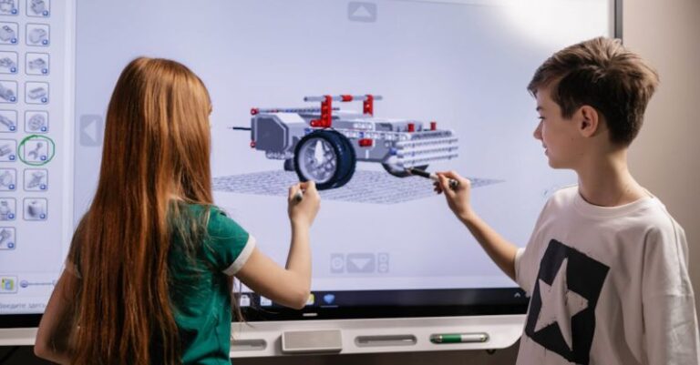 Robotics Technologies - Boy and Girl Standing in Front of Computer Screen