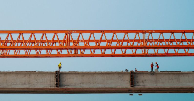 Developments - Construction workers on a bridge with a crane